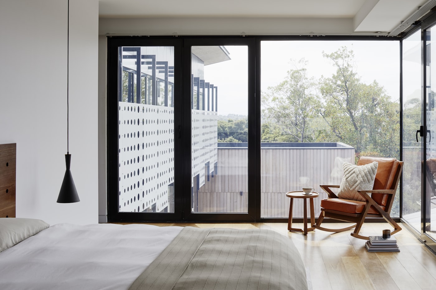 Bedroom with glass doors opening onto a Pasadena view
