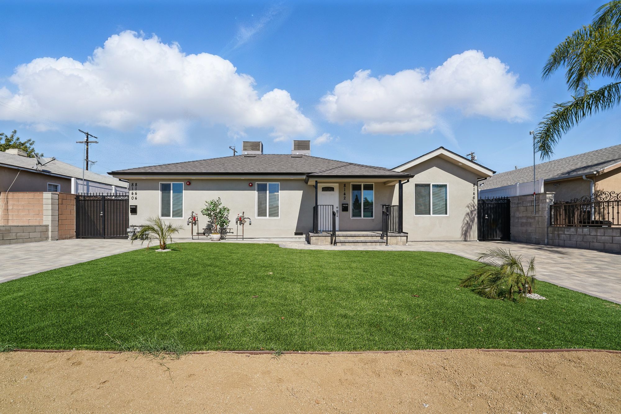 Single-story home with a new lawn and paver driveway