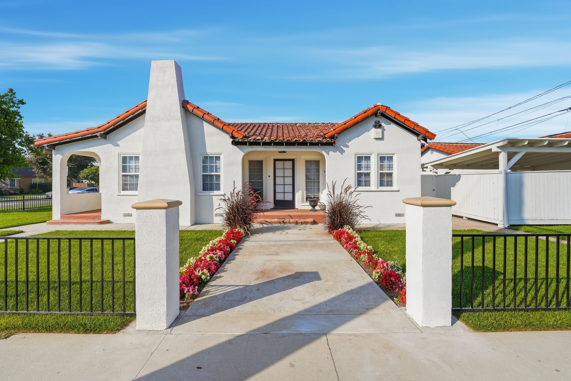 Spanish-style home with a red tile roof listed by The Bonilla Group